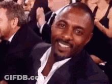 Man In Suit Smiling In Crowd GIF