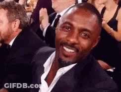 Man In Suit Smiling In Crowd GIF