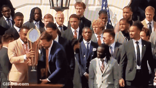 Man In Suit Smiling In Crowd GIF