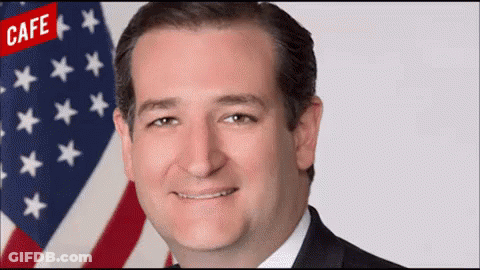 Man In Suit Smiling In Front Of American Flag With Cafe GIF