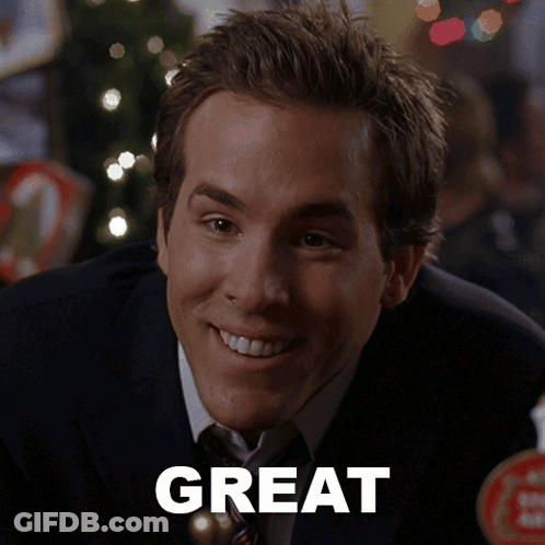 Man In Suit Smiling In Front Of Great Sign GIF