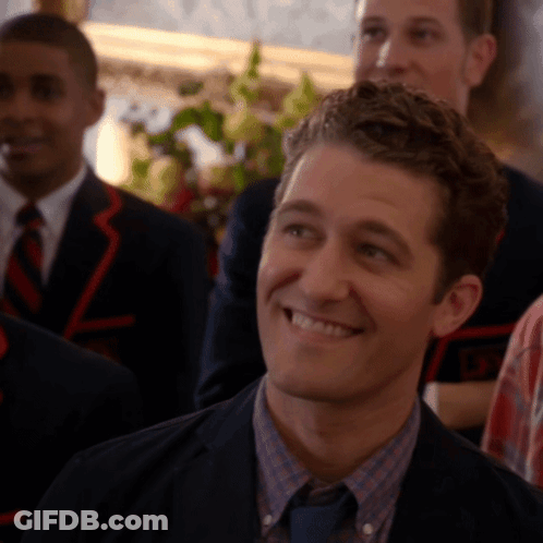 Man In Suit Smiling In Front Of Group GIF