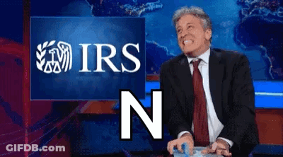 Man In Suit Smiling In Front Of IRS Screen GIF