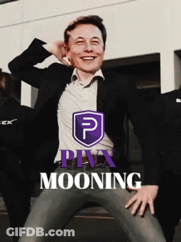 Man In Suit Smiling In Front Of Purple Pivx Mooning Logo GIF