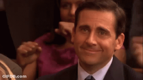 Man In Suit Smiling In Theatre GIF
