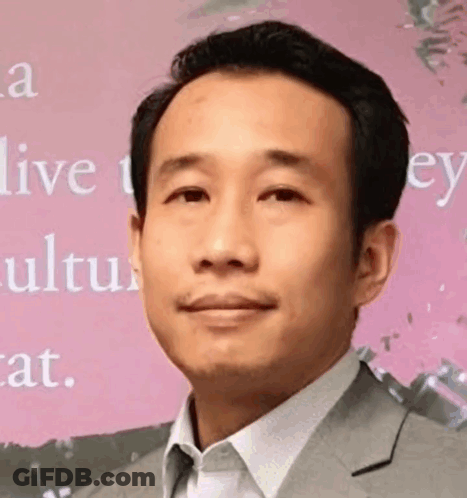 Man In Suit Smiling On Pink Saying Live GIF