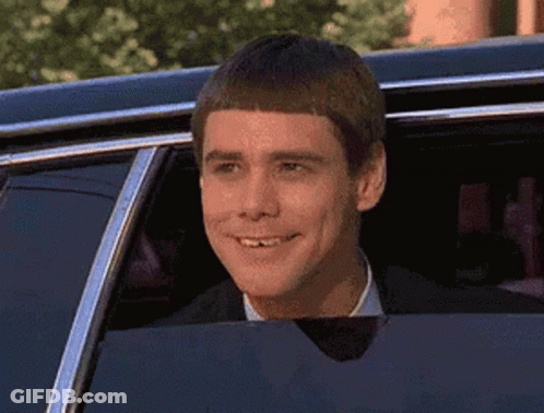 Man In Suit Smiling Out Car Window GIF
