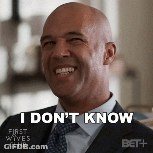 Man In Suit Smiling Says I Don't Know GIF