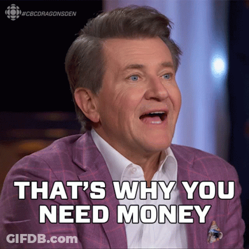 Man In Suit Smiling Says We Need Money GIF