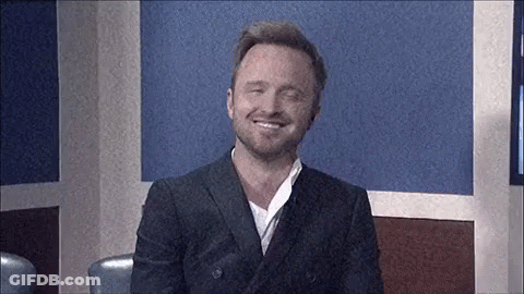 Man In Suit Smiling Sitting In Room GIF