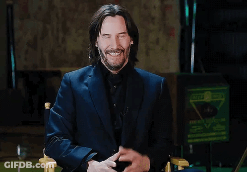 Man In Suit Smiling Sitting GIF