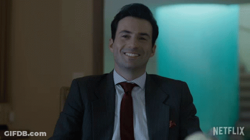 Man In Suit Smiling With Netflix Logo GIF