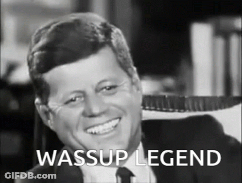 Man In Suit Smiling With Wassup Legend Text GIF
