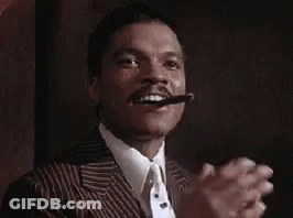 Man In Suit Smoking Cigar And Clapping GIF