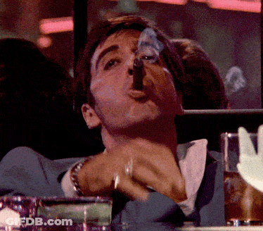 Man In Suit Smoking Cigar At Table GIF