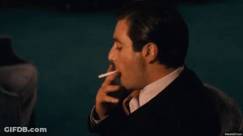 Man In Suit Smoking Cigarette GIF