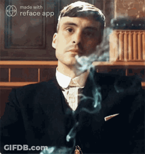 Man In Suit Smoking Cigarette GIF