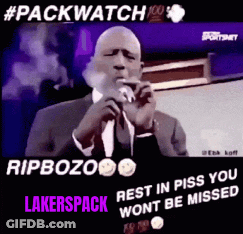 Man In Suit Smoking Cigarette At Microphone GIF