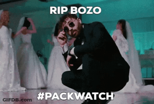 Man In Suit Smoking Cigarette At Microphone Saying Rip Bozo GIF