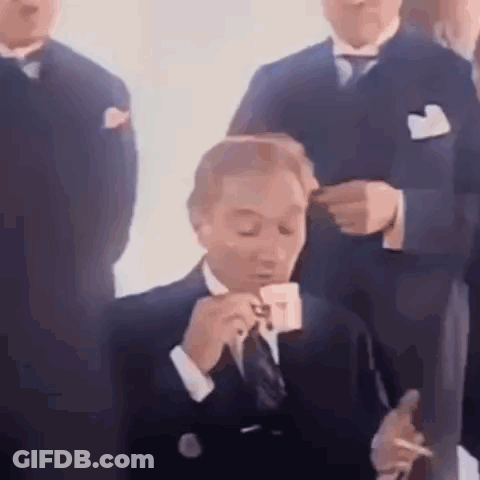 Man In Suit Smoking Cigarette Drinking Cup GIF