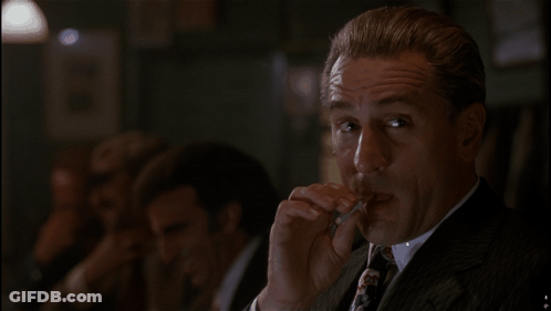 Man In Suit Smoking Cigarette GIF