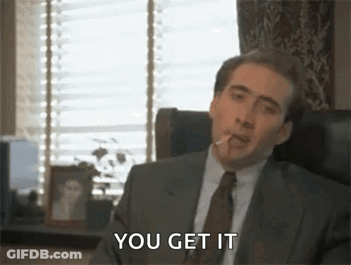 Man In Suit Smoking Cigarette In Chair GIF