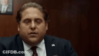 Man In Suit Smoking Cigarette In Dark Room GIF
