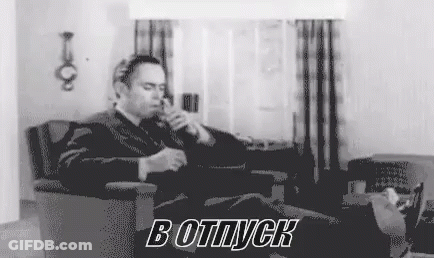 Man In Suit Smoking Cigarette In Living Room GIF