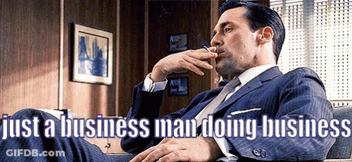 Man In Suit Smoking Cigarette Legs Crossed GIF