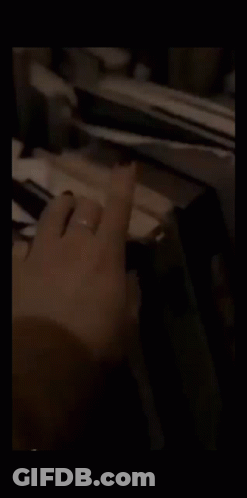 Man In Suit Smoking Cigarette Next To Another Man GIF
