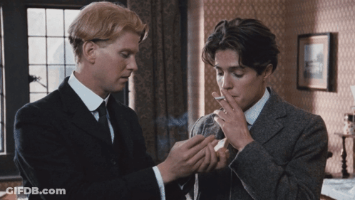 Man In Suit Smoking Cigarette Next To Another Man GIF