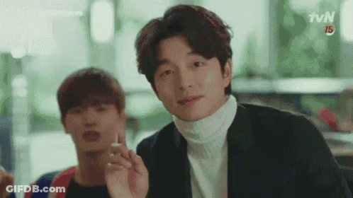 Man In Suit Smoking Cigarette While Another Watches GIF