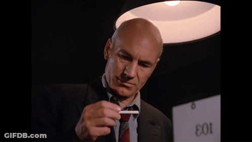Man In Suit Smoking In Front Of EOI Sign GIF