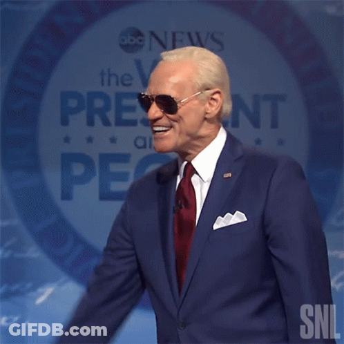 Man In Suit Speaking Into Mic With SNL GIF