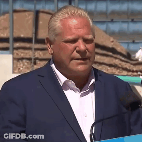 Man In Suit Speaking Into Microphone GIF