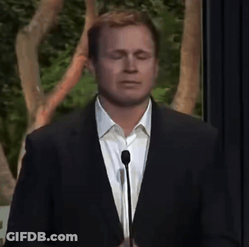 Man In Suit Speaking Into Microphone Eyes Closed GIF