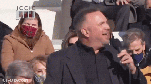 Man In Suit Speaking Into Microphone JCCIC GIF