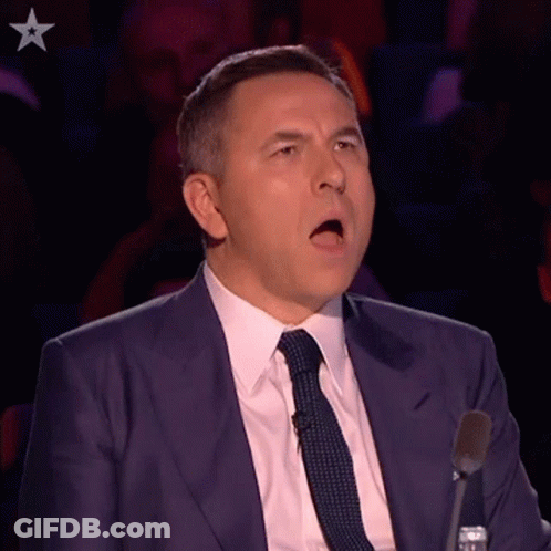 Man In Suit Speaking Into Microphone GIF