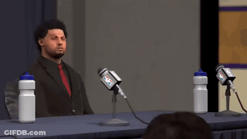 Man In Suit Speaking Into Microphone GIF