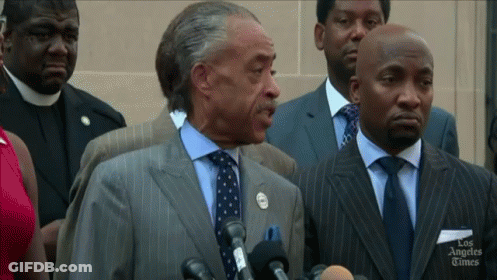 Man In Suit Speaking Into Microphone Los Angeles Times GIF