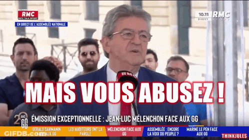 Man In Suit Speaking Into Microphone Mais Vous Abusez GIF