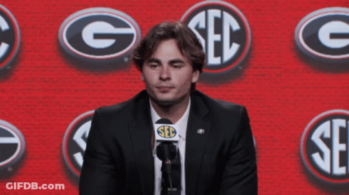 Man In Suit Speaking Into Microphone Saying Seb GIF