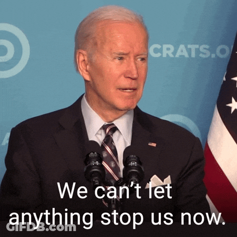 Man In Suit Speaking Into Microphone Saying We Can't Let Anything Stop Us Now GIF