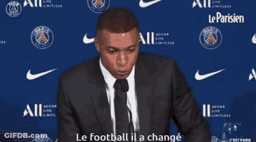 Man In Suit Speaking Into Microphone Says Le Football Il A Changé GIF