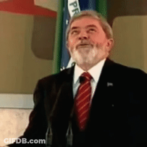 Man In Suit Speaking Into Microphone With PP Flag GIF