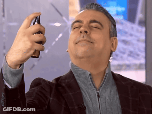 Man In Suit Spraying Face GIF