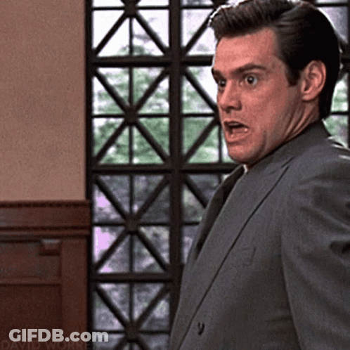 Man In Suit Standing At Window With David Worren GIF