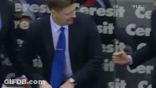 Man In Suit Standing Before Cersit Sign GIF