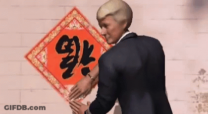 Man In Suit Standing Before Chinese Symbol GIF
