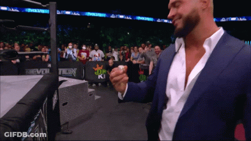 Man In Suit Standing Before Evolve Banner GIF